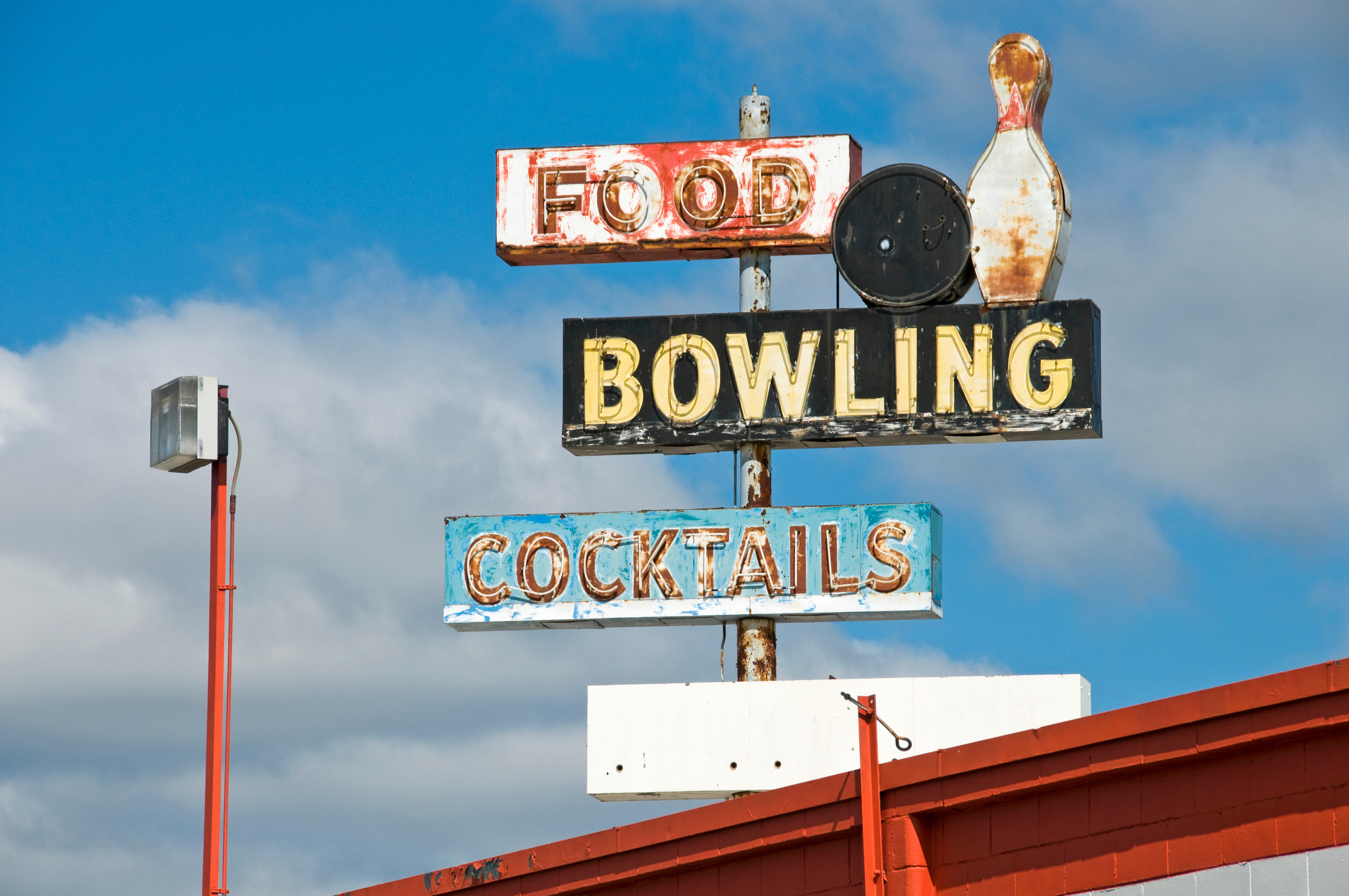 Old bowling alley sign on condemned building